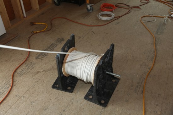 Cable often comes in large spools, and can be dispensed directly from the spool mounted on an axle between two factory-made brackets.  