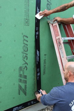 The tape continues to the bottom where it will overlap the horizontal bottom seam.