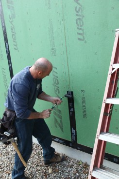 Openings for windows were to be cut out later, so the crew taped up to the bottom of the rough openings.