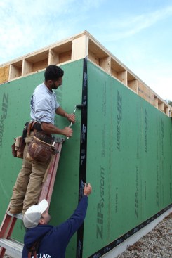 When the initial adhereing is done on the first side of the corner, that side is rolled to keep the tape from moving as it is pulled over to the adjacent wall. 