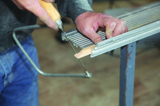 Then cut in from the horizontal side. Because the miter will not be readily visible, the carpenter opts for a square cut on the horizontal side.