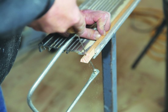 He then follows the profile until the cuts meet, keeping the saw at an angle to create a back bevel.