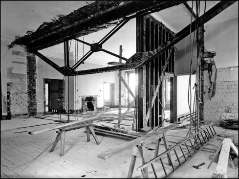 Inadequate interior foundations, installed during its original construction in 1800, were further compromised by major renovations in 1902 and 1927. In 1902, a load-bearing wall was removed to enlarge State Dining Room on the first floor (the floor and walls above were supported by a steel truss and suspended rod system shown in the photo above). The truss, located within a second-floor West Sitting Room wall, transmitted concentrated loads to already burdened interior foundations. More worrisome was the 1927 addition built during the Coolidge administration where a third-floor level was expanded into existing attic space. The new concrete-and-steel story transferred much of its weight onto the interior walls (up until then, the original roof and unused attic floor were supported only on the heavy exterior walls). Coolidge’s third-floor addition would accelerate the White House’s structural demise, the warning signs of which were largely ignored by the succeeding Hoover and Roosevelt presidencies too busy with trying to navigate the country through the Great Depression and later World War II.