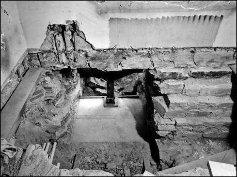 A “T”-shaped structural steel support is installed on top of a cured “underpinning” pier, then…