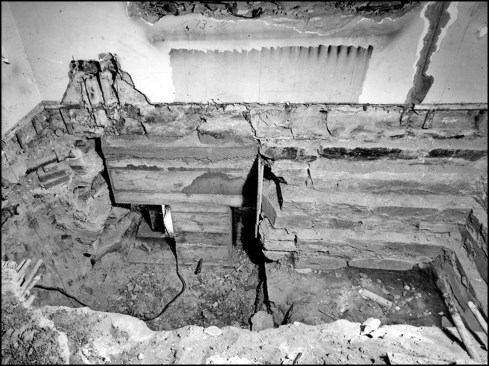 …later formed out and filled with concrete. The “T”-shaped concrete pours allowed access to the interior to remove earth. The process was repeated and the existing stone foundation was gradually removed. The access holes were later infilled with concrete.
