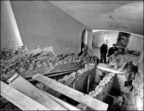 Workmen remove limestone steps from the main stairway of the White House. To accommodate increasing project costs and time constraints, most of interior finishes ended up being copies of the original. By mid-February 1950, the dismantling of the White House was complete and demolition was well under way.