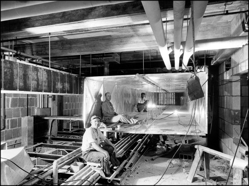 Photographer Abbie Rowe staged workmen inside ductwork to illustrate the size of the massive HVAC system being installed in the new basement. Prior to the Truman Renovation, White House operations were significantly reduced during summer months as people departed the heat and humidity of Washington, DC for more hospitable climates. Air conditioning allowed the White House to operate year-round without regard for summer heat.