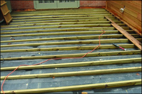 …most clients prefer a level walking surface, so sleepers are typically tapered. Note, the tapered sleepers rest on a loose-laid EPDM “protection layer” placed over the roof’s TPO membrane.