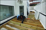 Where the roof deck is enclosed by a masonry parapet, ledgers can simply be bolted to the house framing and parapet to support standard deck joists.