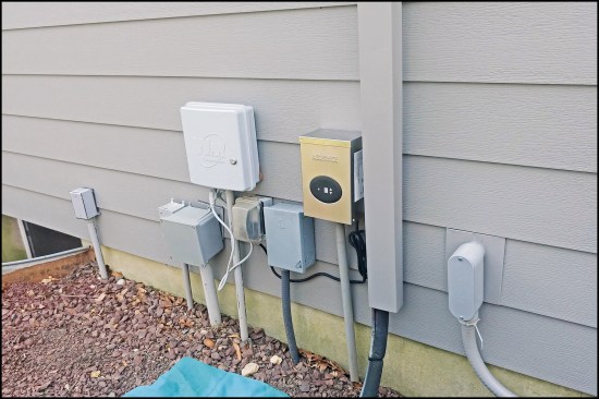 Here, the AC lines are capped with matching coil stock fabricated on site—much better than the usual white leader pipe. Instead of the usual mounting blocks, a plate made from coil stock overlays a narrow block, allowing the siding to move underneath.