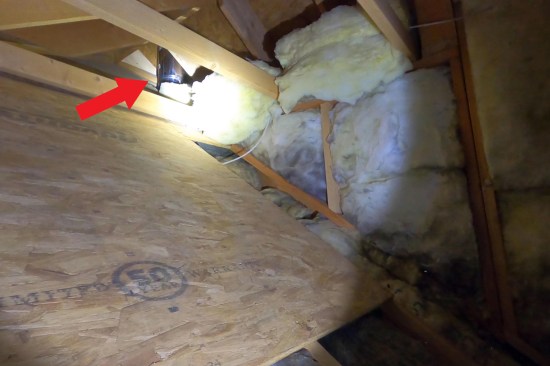 Under the stick-framed portion of garage wing’s roof, roughly 24 inches of flue pipe was left exposed. The flue, connected to a wood burning stove located on the first floor, contributes to the warming of the unconditioned space behind the connecting “hall” and adjacent bonus room knee wall.
