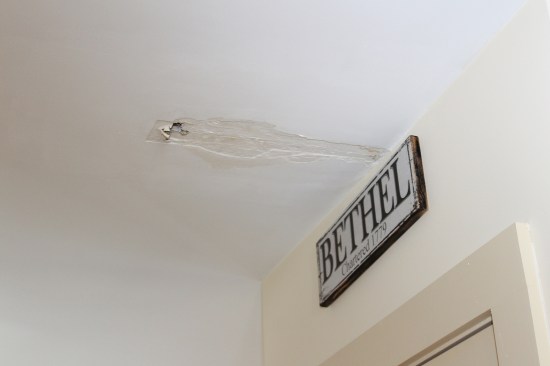 An interior ceiling leak, located at the juncture between main house and garage wing, was misattributed to ice damming.