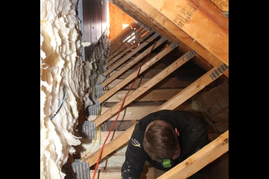 The 2x4 web members of the attic trusses, which act as the knee wall, were infilled with 6-inch-thick kraft-faced R-21 batts. Two inches of the existing fiberglass was removed from the back of the batts to prevent compressing them when we installed a layer of 2-inch XPS insulation (the XPS would serve as the primary air barrier between the bonus room and the cold space behind the knee wall). Compressing the batts would affect the insulation’s “lofting”, reducing its performance.