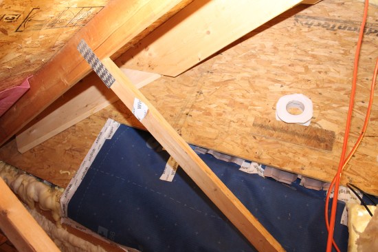 Here above the foamed-in LVL beam, the Majvest was taped on the back of the existing baffles and the Majvest was then taped to the existing roof sheathing. Not an ideal assembly, but given the client’s budget and their desire to avoid interior demolition, the author wanted to create a continuous air-seal, making sure the baffles would keep venting to the main roof’s ridge vent.