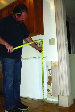 Next, he sets a laser level at final countertop height, accounting for appliances like dishwashers or stoves.