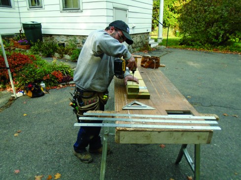 Author screws a two layers of material to the back of the ledger so that it will hang clear of the foundation.