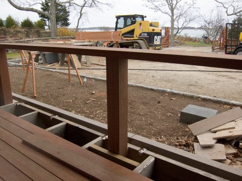 We secured the posts to the 2x10 deck framing with solid blocking and TimberLok screws. Prior to installing the railing assembly, I pre-checked the sub-rail and railing cap’s fit between the 14-inch-square columns by aligning a long, straight test piece with squared ends, spanning the 4x4 posts, noting any out-of-square issues. With few exceptions, the columns were remarkably in parallel, a tribute to Cregg’s careful execution and a relief to me. The test piece allowed me to gauge and correct for small discrepancies from square, adjusting the slide compound saw accordingly. Here, the 2x6 mahogany sub-rail is attached to the 4x4 posts with #10 x 3-1/2-inch stainless steel screws.
