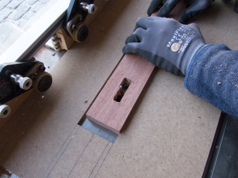 Liam used another jig, clamped to a router table, to clean up the perforation profile with a 1/8-inch-radius solid carbide straight bit. We re-adjusted both jigs for each of the five groups.
