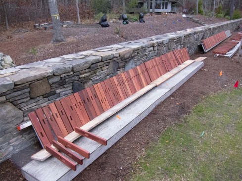 They placed the finished slats on drying racks, laying them out to our color-coded assembly order.
