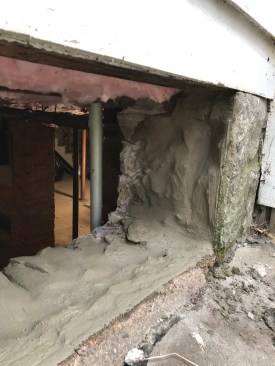 Using Type-N mortar, I secured the loose stones and then applied a coat of new mortar to the entire opening, brushing it smooth.