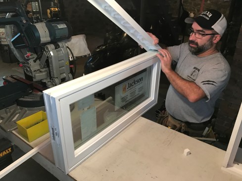Each window came with a head expander that slides up to fill the gap at the top of the window. I applied polyurethane low-expansion foam to each expander and slid it onto the top of a window.