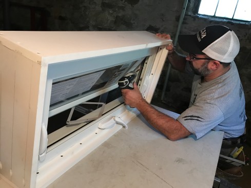 Opening the windows let me access the holes for securing the units to the frames, which I did with four screws short enough not to go through the frames.