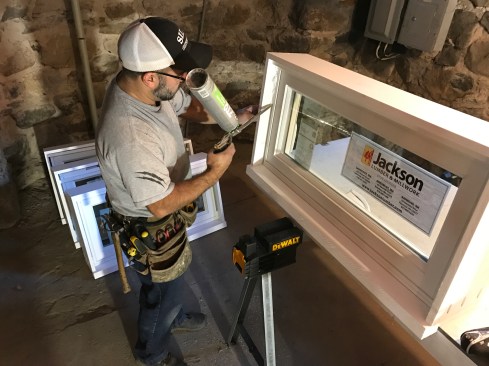 I filled the gap between the window and the frame with low-expansion foam and installed the stop to keep the foam from oozing out.