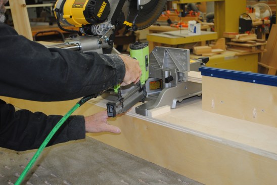 Bolts and wing nuts replace the screws at a later time. Nail blocks around the saw feet to ensure perfect placement in the stand each time the saw is set up.