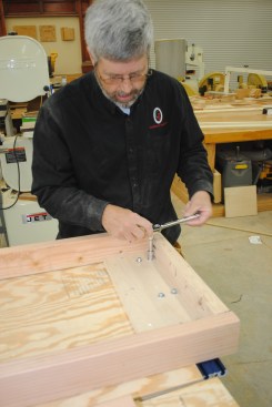 The overhang helps with clamping work to the table. Lay out the track the same as with the miter-saw stand, and attach it with nuts and bolts.