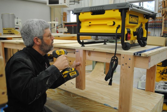 Screw 2x4 braces to the table frame to hold the saw platform.