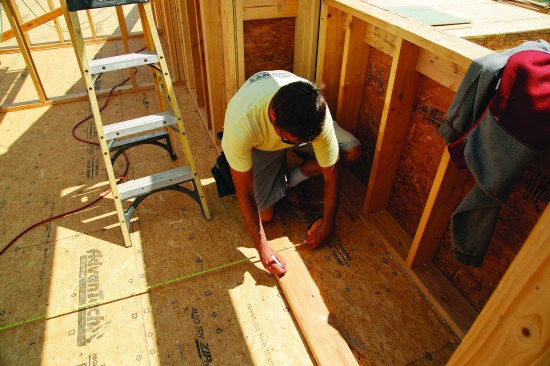 To find the length of the ridge, the author measured to the outside of the wall framing.