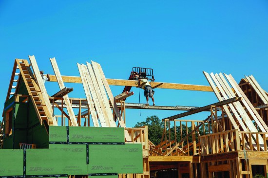 After releasing the straps holding the ridge on the telehandler forks, the crew was ready to install the ridge.
