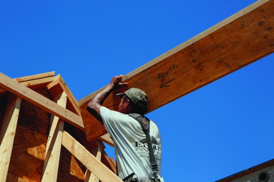 The crew pulled the ridge back so that one crew member could shoulder the end of the ridge onto the ledger.