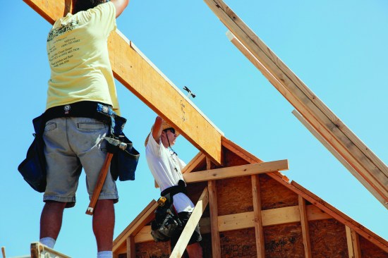 One of the crew tapped the ridge down into place.