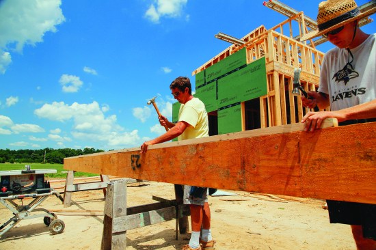The crew attached a ripping of 2-by stock to the top of the ridge for setting the height of the rafters.