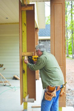 Then he nailed pairs of horizontal 2x4 spacers to the top, middle, and bottom of thepost for attaching the second half of the column.