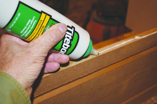 Each face of the column butts on one side and laps over the other. After routing the panel pattern into a few sides, the author assembled them in pairs, running a bead of glue down the edge of one side.