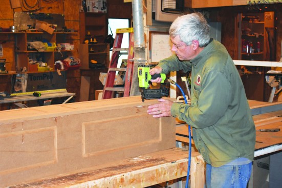 To hold the two adjacent sides in alignment, he tacked them together with brads.