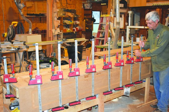 Then he fully clamped the assembly and moved on to the next pair of panels while waiting for the glue to set.