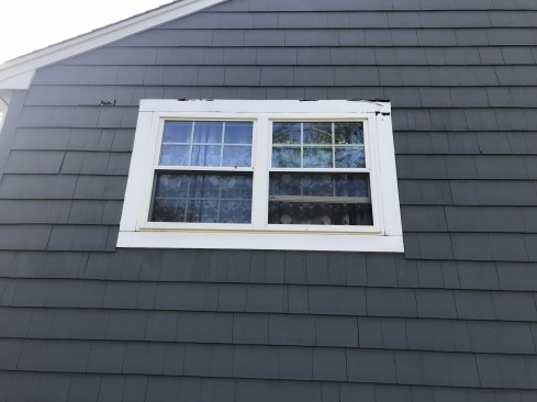 Areas of rot could be seen from the ground on both the window trim and the cedar shingle siding. 