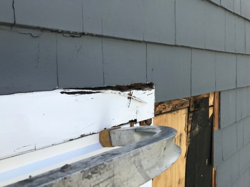 A closer check revealed the causes of the rot: No drip cap had been installed over the window casing, and the siding was caulked to the casing with no drainage gaps.