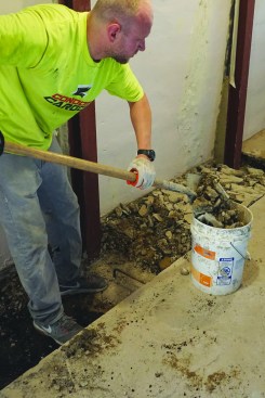 When all the beams were set and the concrete cured, the crew removed the rest of the slab between the wall and the line they
scored earlier with a saw.