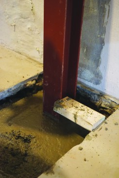 After removing the 6-inch block and leaving the beam temporarily suspended from the joist, they poured concrete to within 4 inches of the top of the slab.