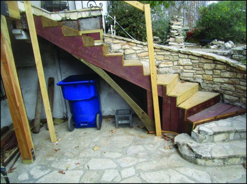 The new stairs were built with pressure-treated 2-by stock and PT plywood with compatible screws.