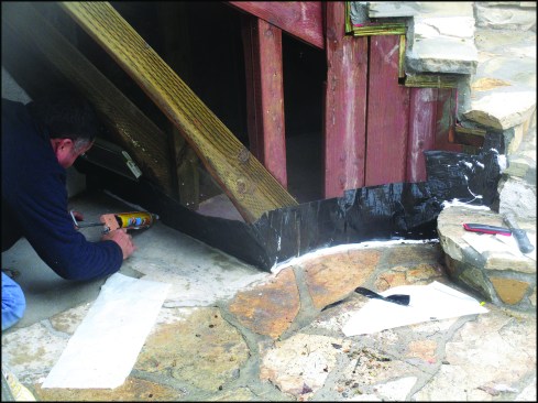To prevent water intrusion, flashing that runs up the framing was sealed to the masonry.