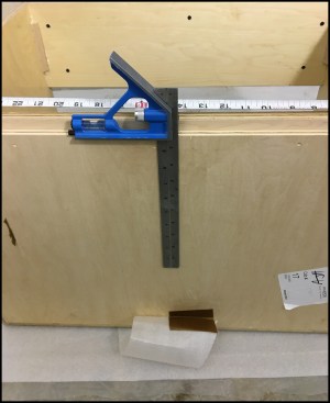 He starts by marking a centerline on the cabinet’s back panel with a combo square, then he marks the centerline on the wall at its ultimate location.