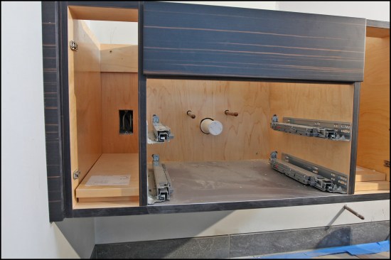 More typical, “tighter” 3/4-inch holes were cut for 1/2-inch supply-line pipes in another vanity unit. Also, an electrical box was cut inside the cabinet (electrical boxes are similarly measured, though cut-outs are made with a multi-tool or jigsaw).