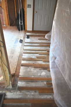 To extend the existing strip flooring into the new kitchen space,we spliced in new flooring, which the flooring contractor did a masterful job of staining to blend old with new.