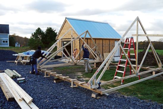 Since the smaller (20x20) roof was built several feet from a new garage, we braced the first gable truss to that.