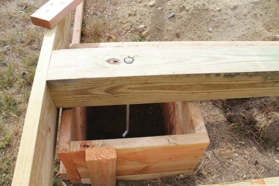 For a cantilevered shed, the main floor beams were assembled on top of the form boxes. The anchor bolts were installed before the pour, ensuring perfect bolt placement.
